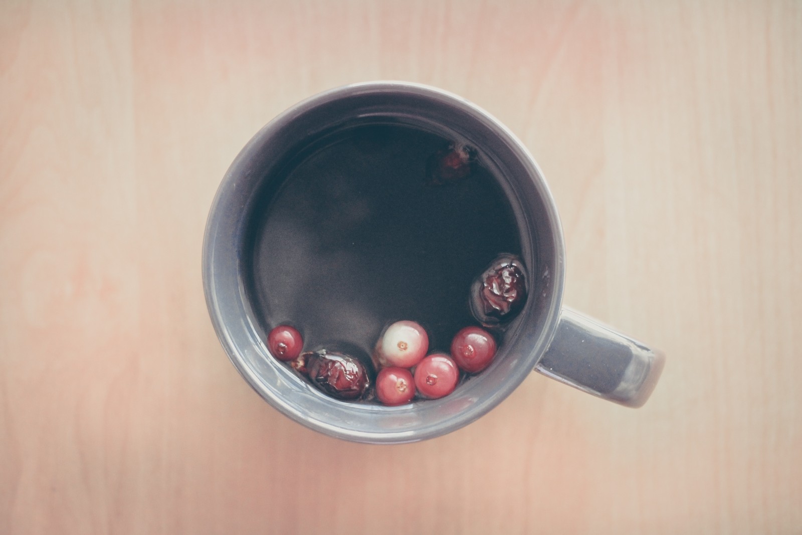 Cup of tea with floating berries